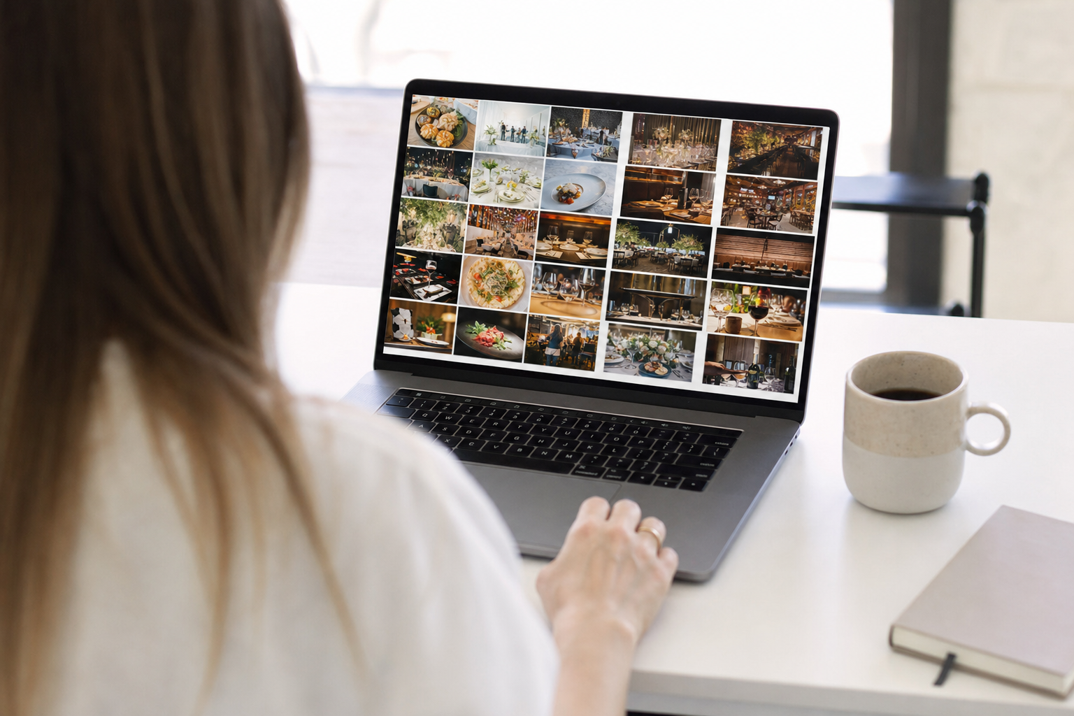 A client browsing a clean searchable photo gallery of professional shots on a laptop in a bright workspace.
